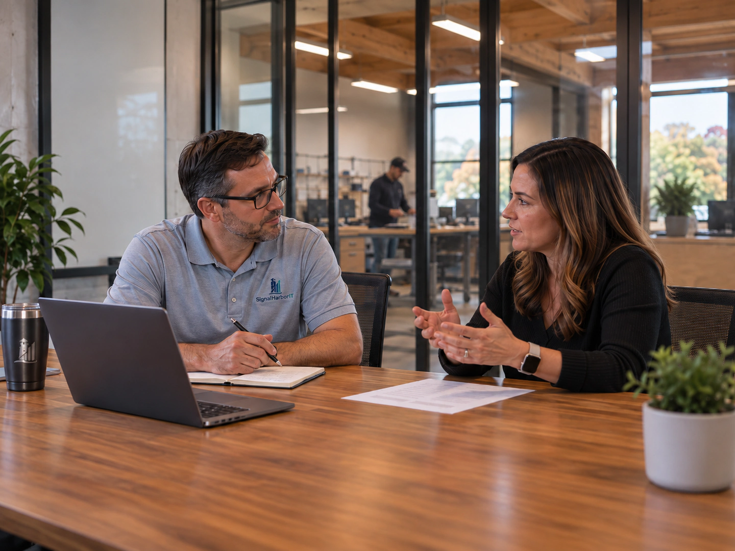 SignalHarbor IT adviser discussing technology needs with a business professional.